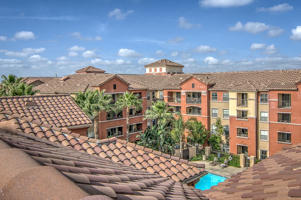 an aerial view of the courtyard of an apartment building with a pool