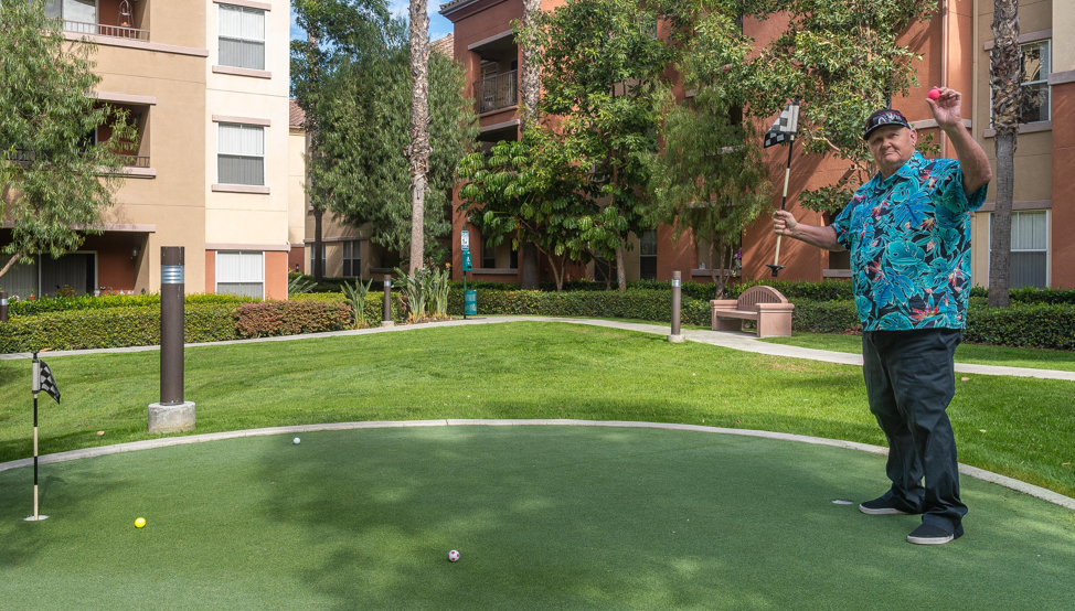 a man is playing golf on a mini golf course