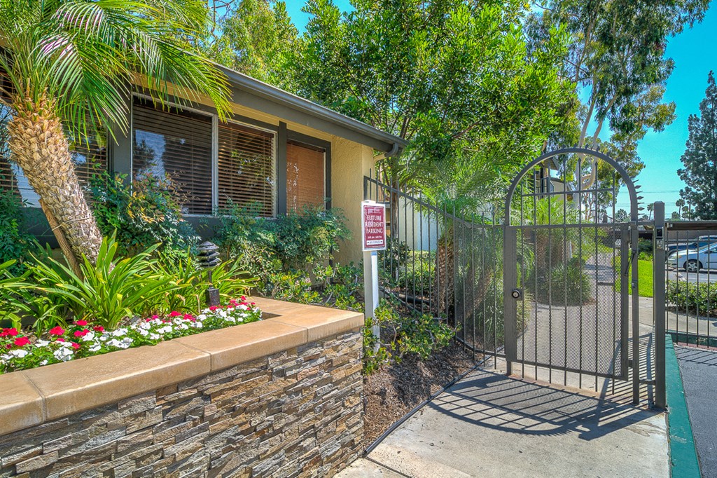 a house with a gate with a sign on it