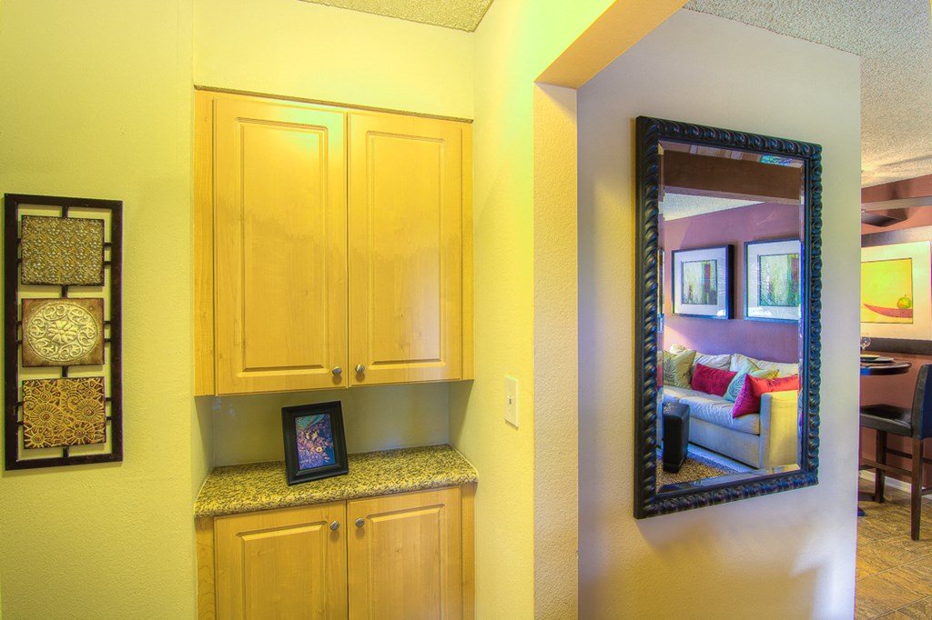 a bathroom with a vanity and a mirror and a living room