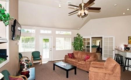 a living room with a couch and a ceiling fan