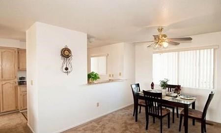 a dining room with a table and a ceiling fan