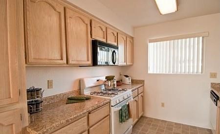 a kitchen with a stove and a microwave