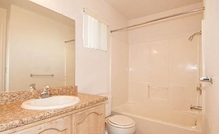 a bathroom with a sink toilet and a shower