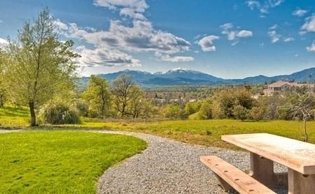 a park bench sitting on a gravel path