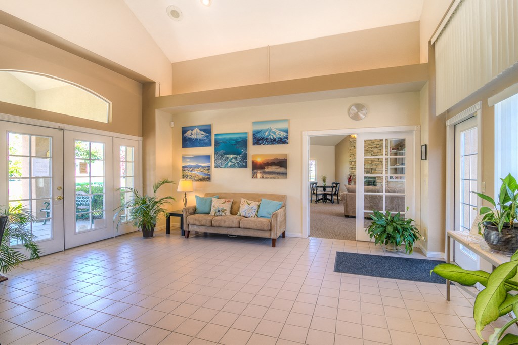 a living room with a couch and a door to a dining room