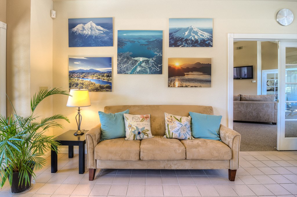 a living room with a couch and many pictures on the wall