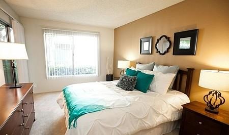 a bedroom with a large bed and a window