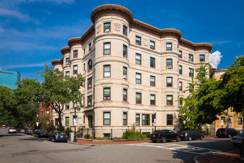 a large building on the corner of a city street