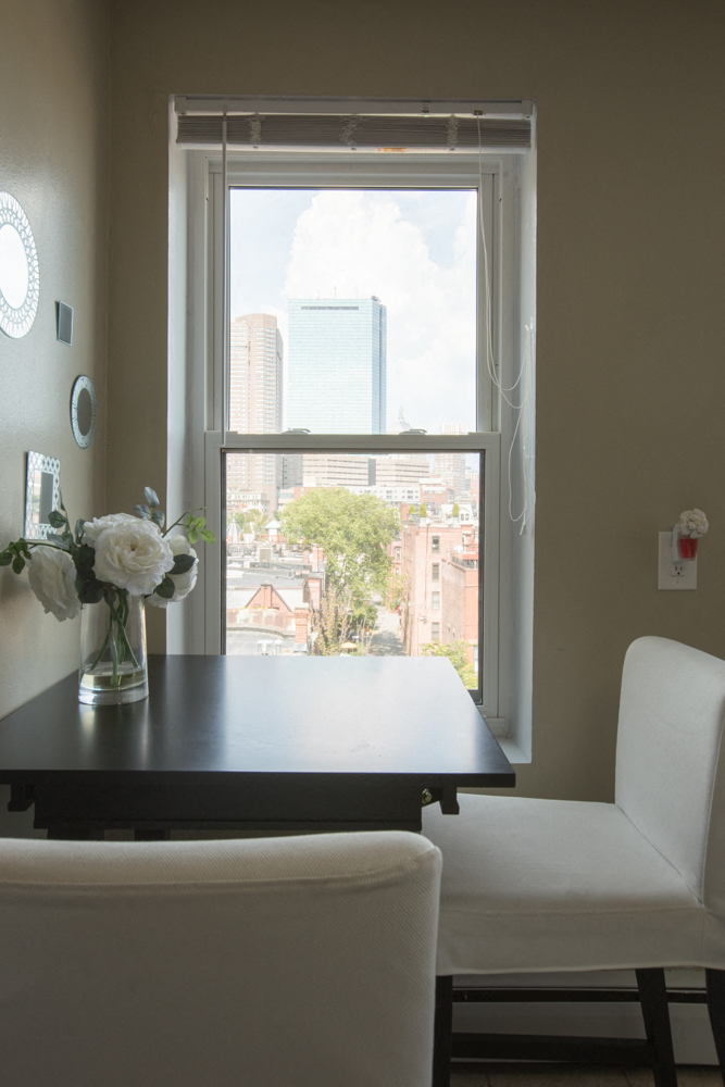 a dining room table with a view of a window