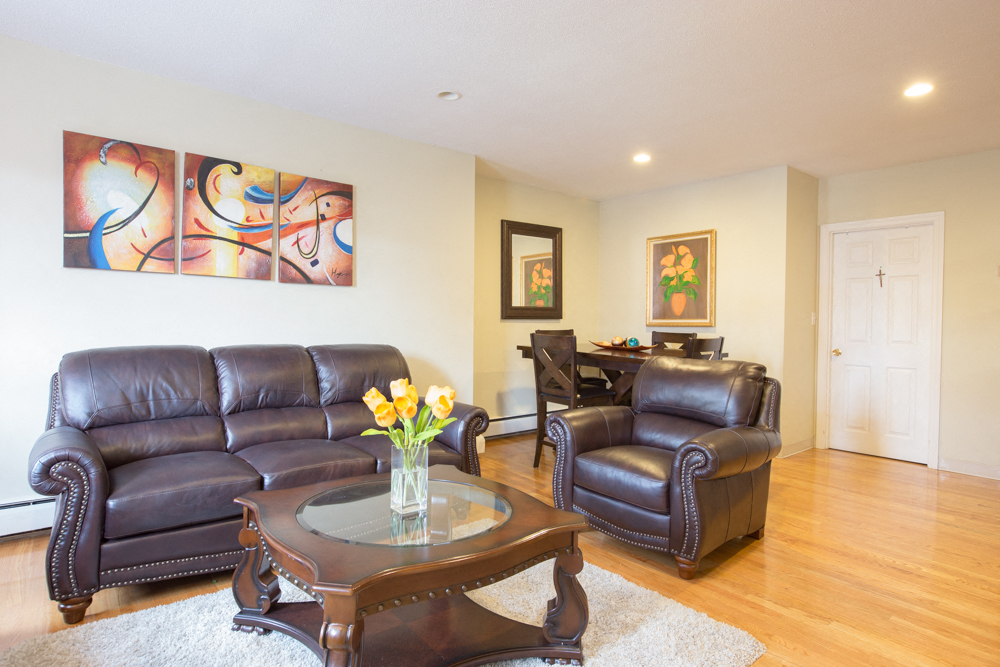 a living room with leather couches and a coffee table