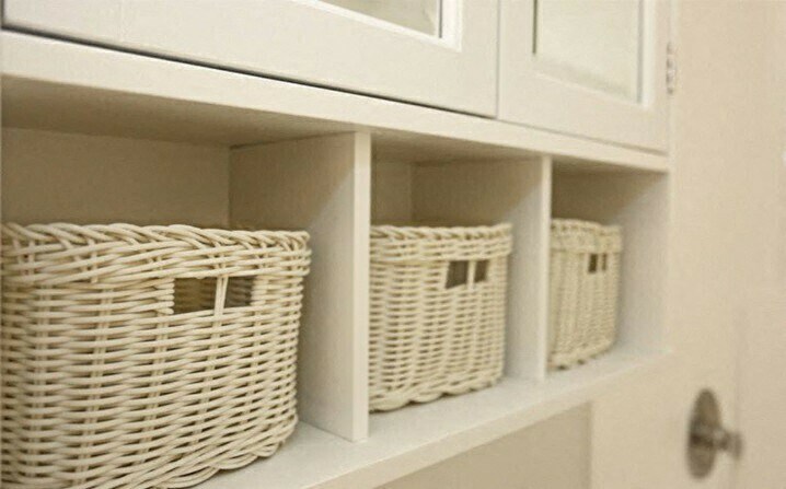 three baskets on a shelf in a closet