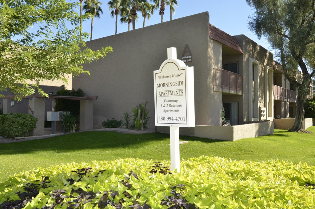 a sign in the front yard of a house