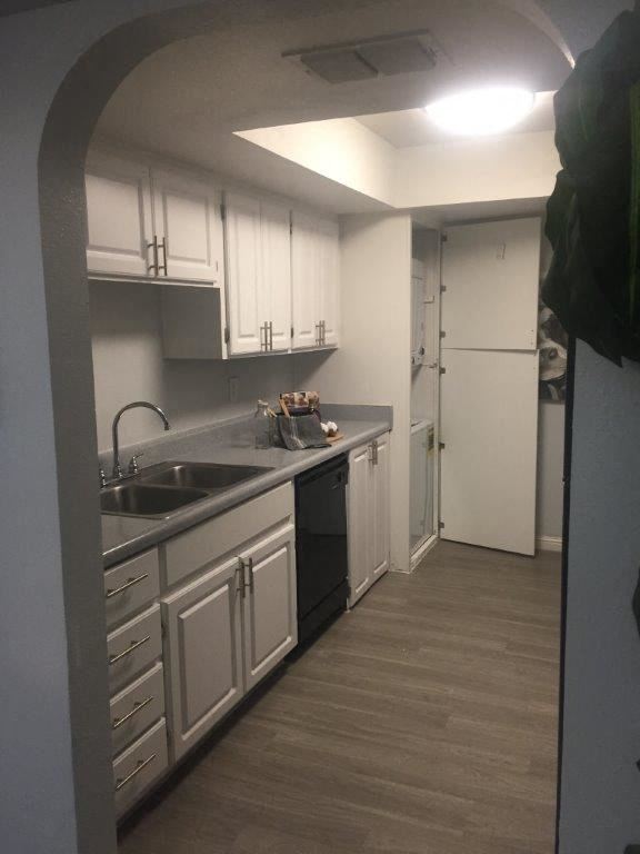 a kitchen with white cabinets and a sink