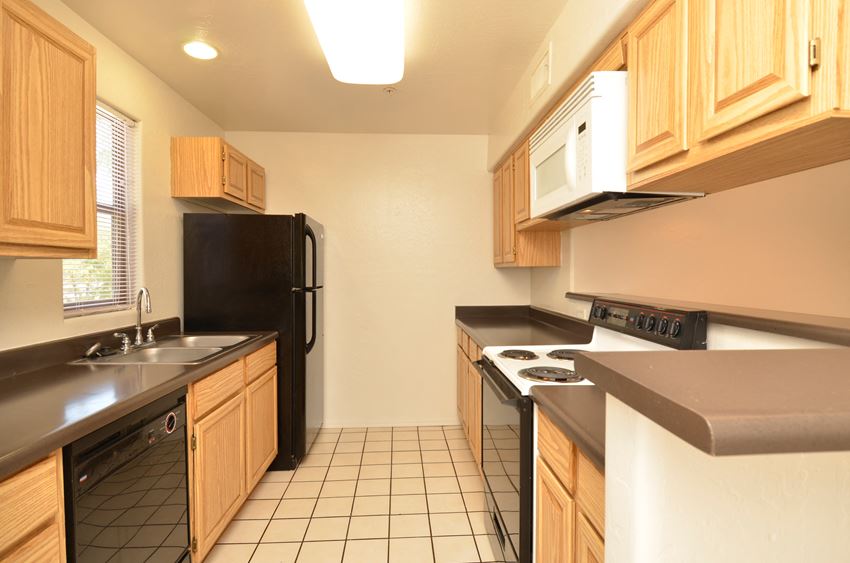a kitchen with a stove refrigerator and sink