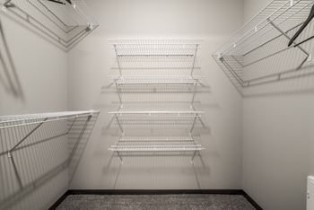 Huge walk-in closet with plenty of shelving  and hanging space at The Villas at Falling Waters in Omaha, NE