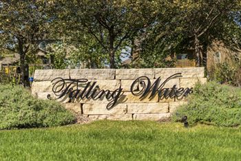 A sign that says Falling Water in front of a house.