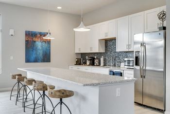 A kitchen with a bar area and stools.