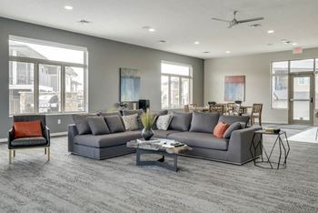 A grey sectional sofa with a coffee table in front of it.