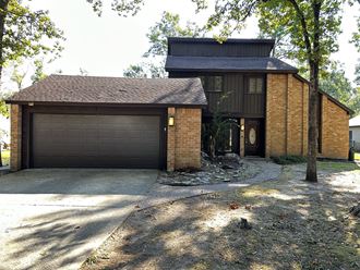 a brick house with a garage and a driveway