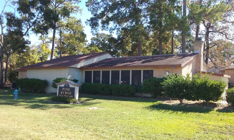 a house with a yard and a sign in front of it