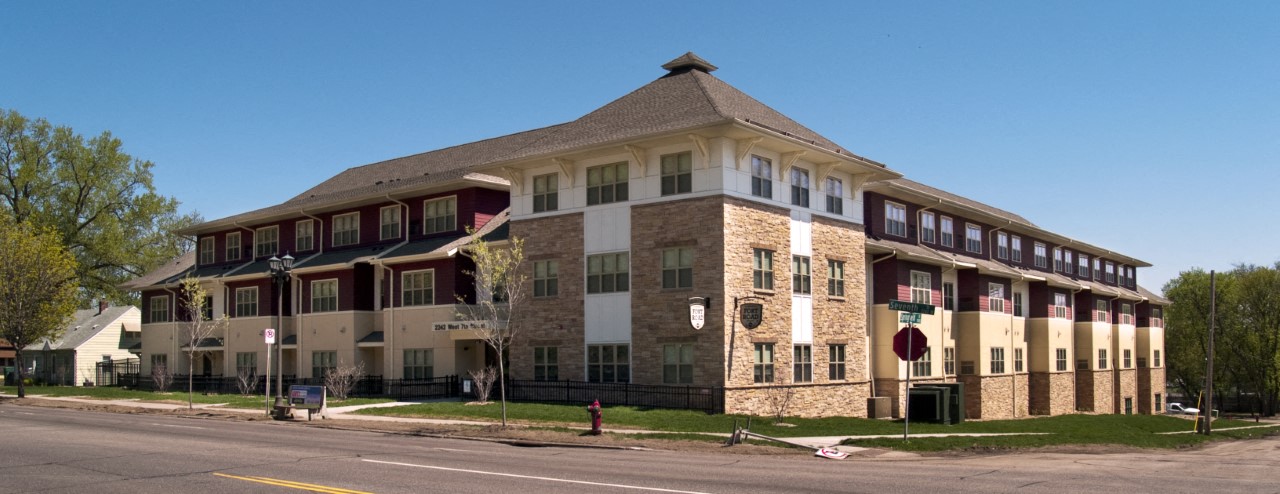 A large building with a mix of beige and brown bricks.