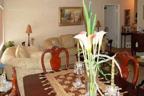 a living room with a couch and a table with flowers