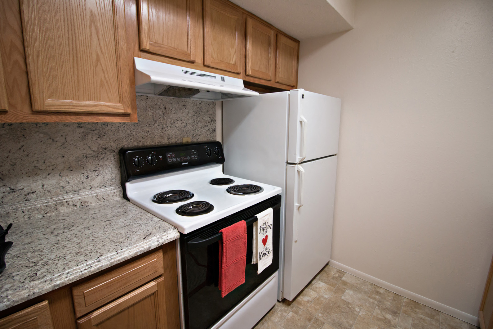 a kitchen with a stove and a refrigerator