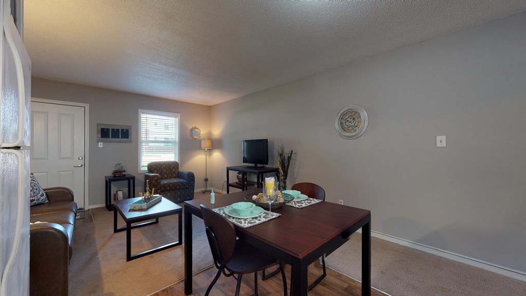 an open living room and dining room with a table and chairs