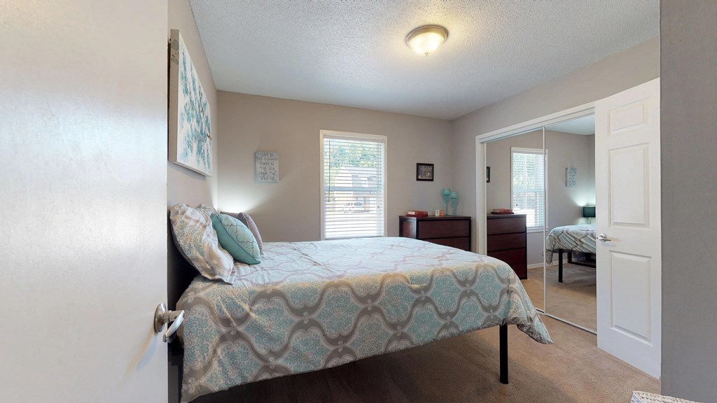 a bedroom with a bed and a closet