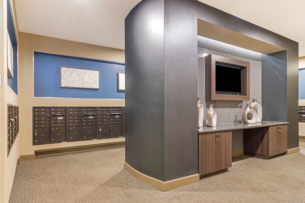 A room with a blue wall and a grey column.