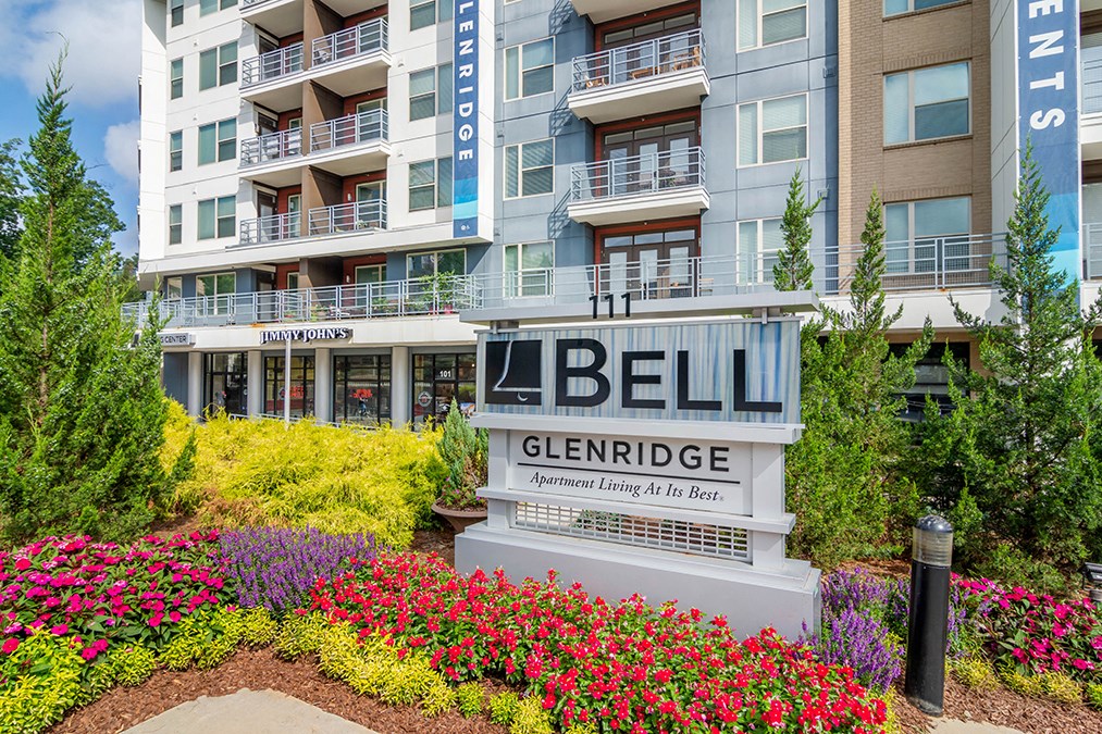 A sign for Bell Glenridge Apartment Living is in front of a building.