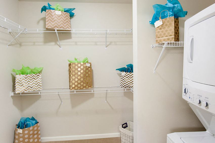 a washer and dryer in a laundry room with gift baskets