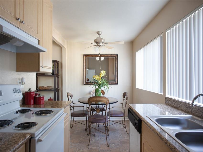 a kitchen and dining room with a table and chairs