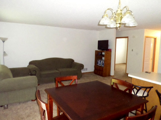 a living room with couches a table and a tv