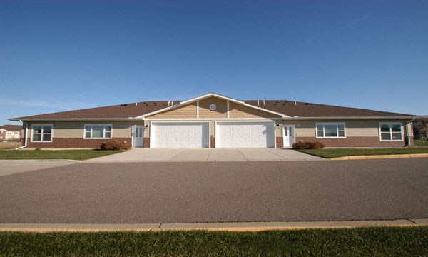 a brick house with a garage and a driveway