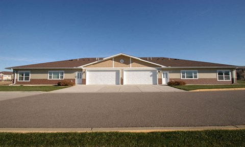 a brick house with a garage and a driveway