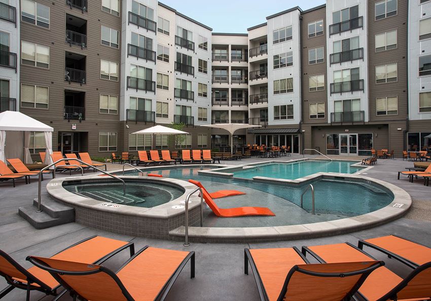 Image of pool and orange lounge chairs