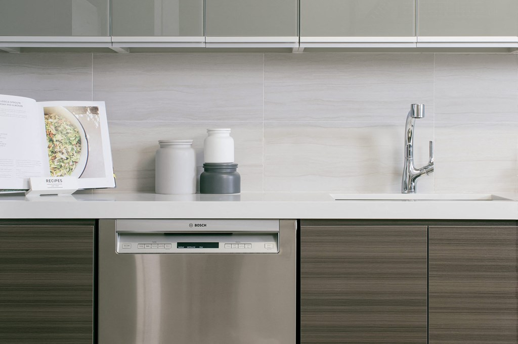 a kitchen with a sink and a book on the counter