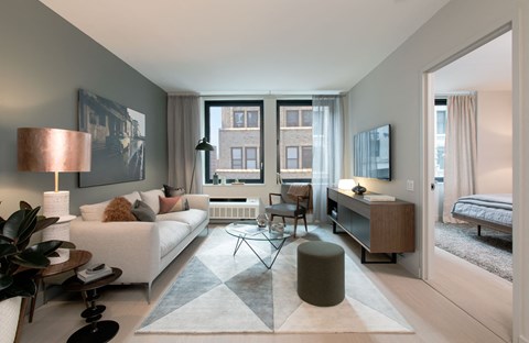 a living room with a couch and a table and a window