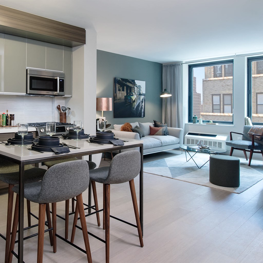 a kitchen and living room with a table and chairs