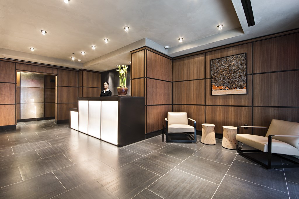the lobby of a hotel with a reception desk and chairs