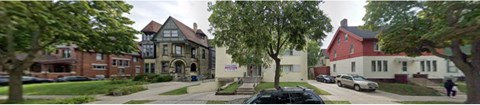 a view of a street with houses and trees