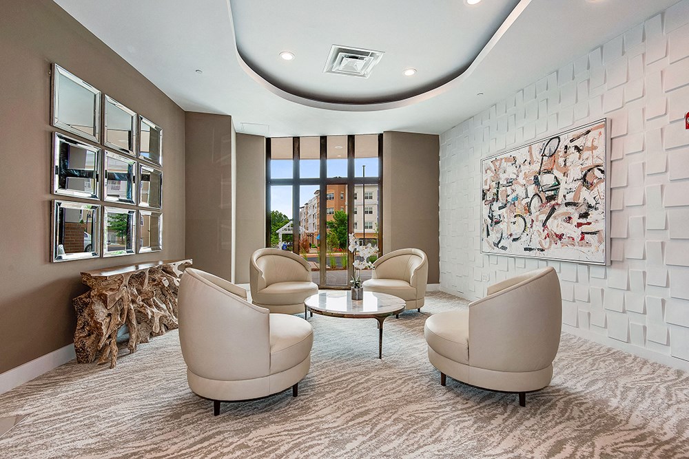 a living room with chairs and a table