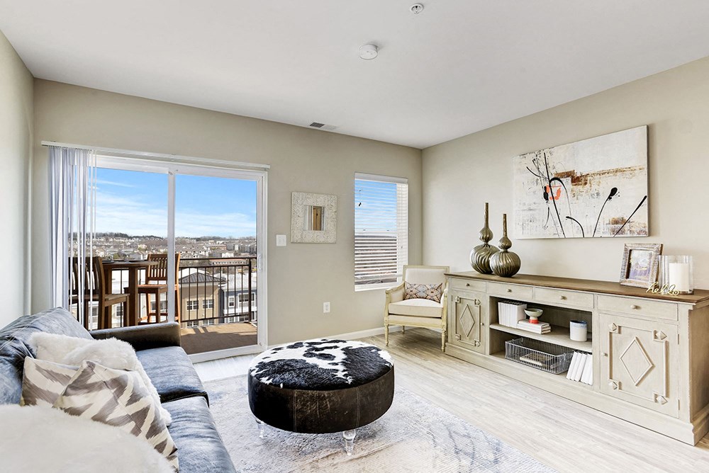 a living room with a sliding glass door and a view of the city