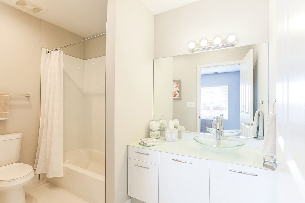 a bathroom with a shower and a sink and a mirror
