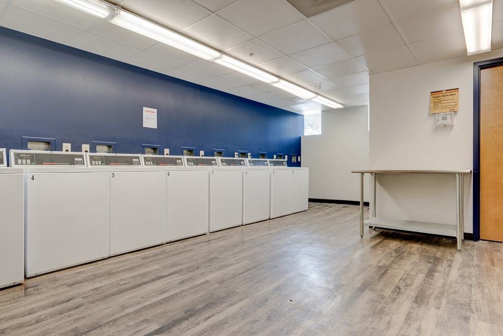 a room with a row of mailboxes and a blue wall