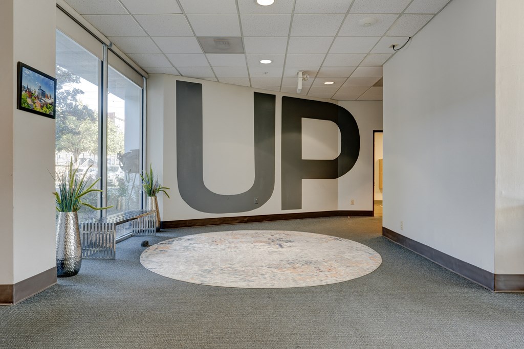 a large logo on the wall in a hallway of a building