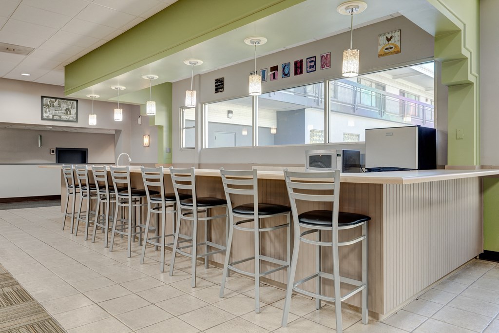a bar with stools at a counter in a lobby