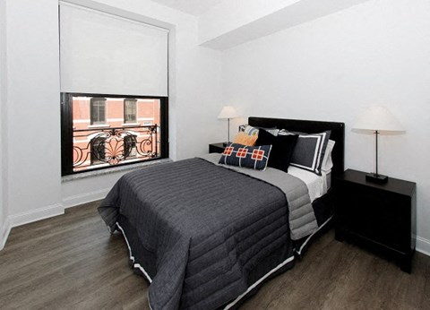 a bedroom with a bed and a window